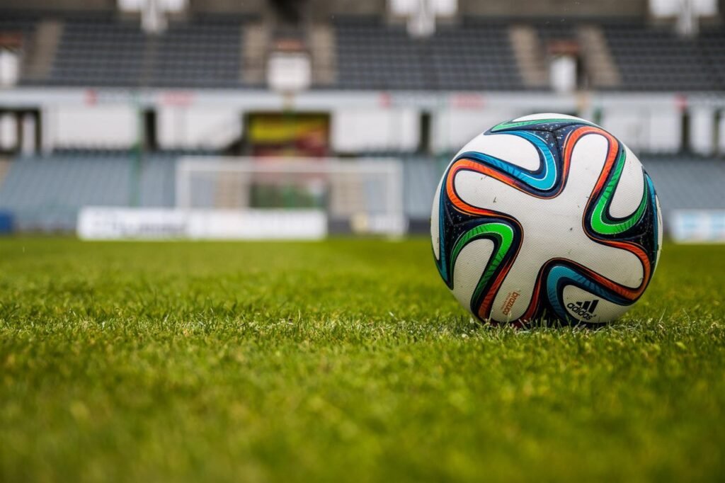 Crafting Captivating Headlines: Your awesome post title goes here Vibrant soccer ball on a lush green field in an empty stadium.